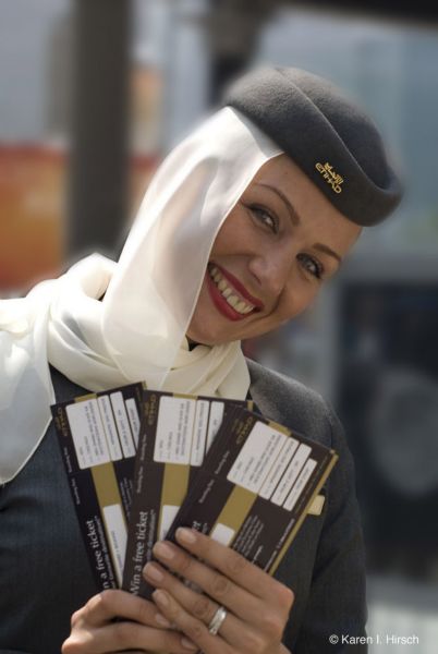 Middle Eastern Flight attendant with airline tickets